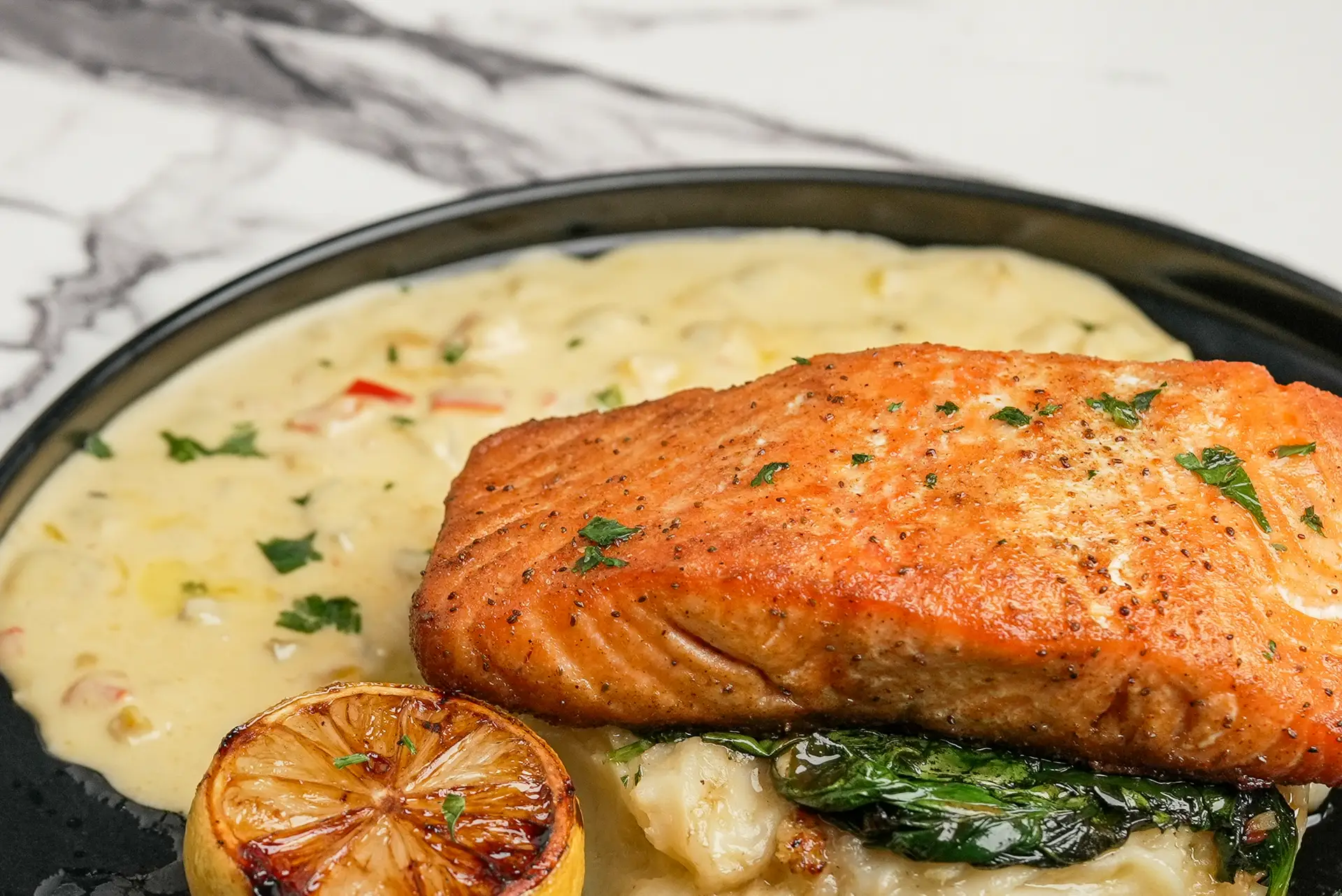SALMON FILET Cajun or Grilled, Mashed potatoes, beurre Blanc, and roasted asparagus.